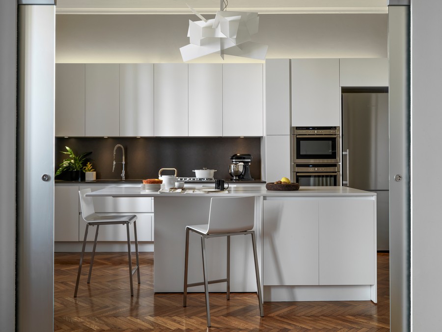 Image is of a while color-scheme kitchen in a modern home.