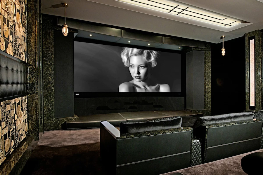 Luxurious home theater showing a large TV display with a black and white image of a woman. 