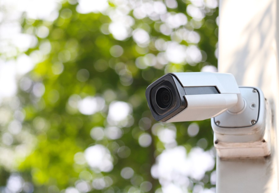 A security camera installed in the outdoor area of a home