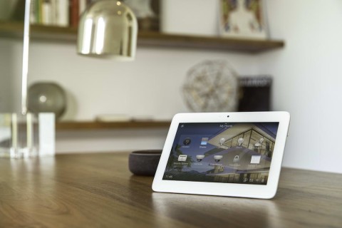 A white tablet displaying a Control4 smart home interface. 